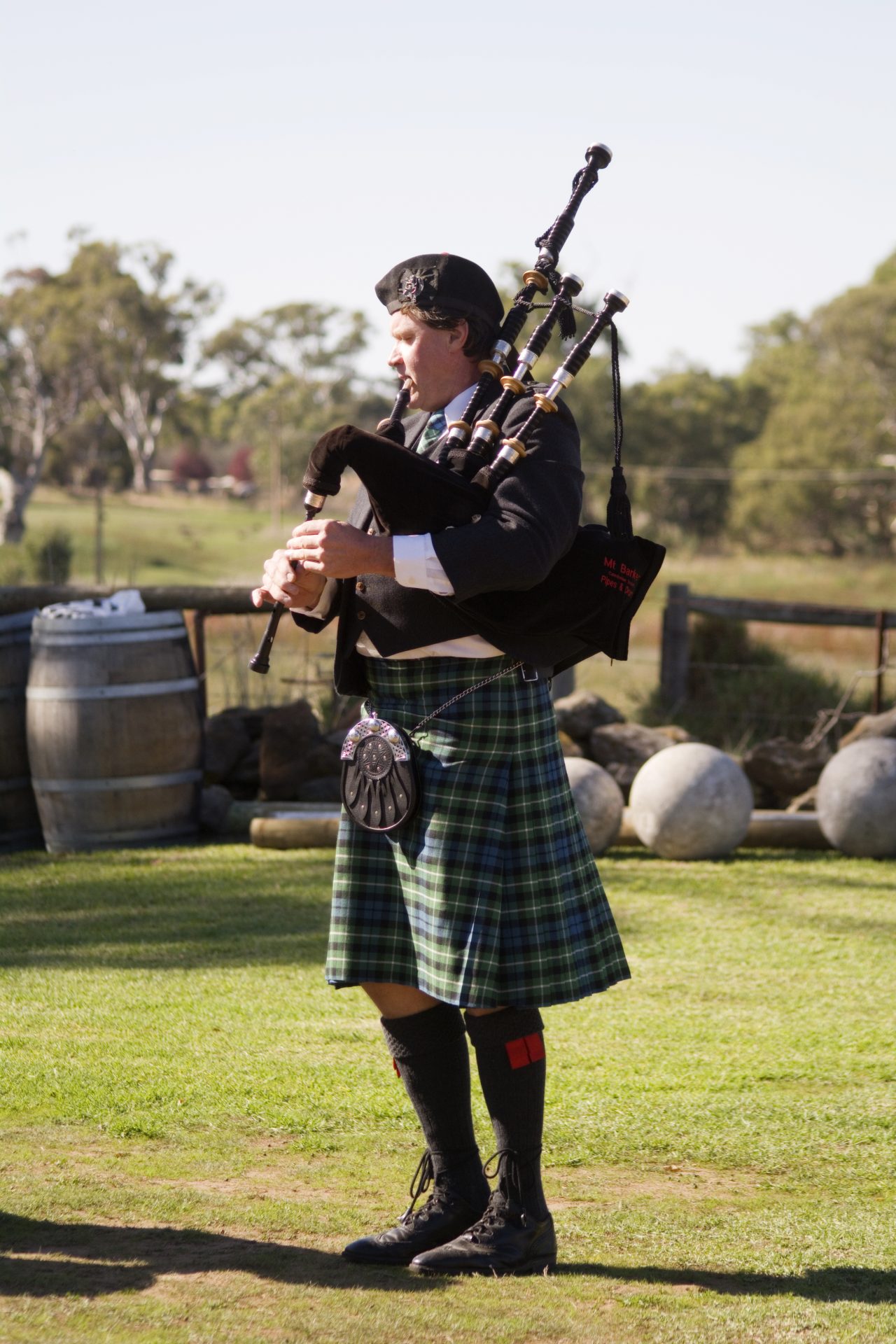 Bagpiper wearing kilt and full Scottish dress